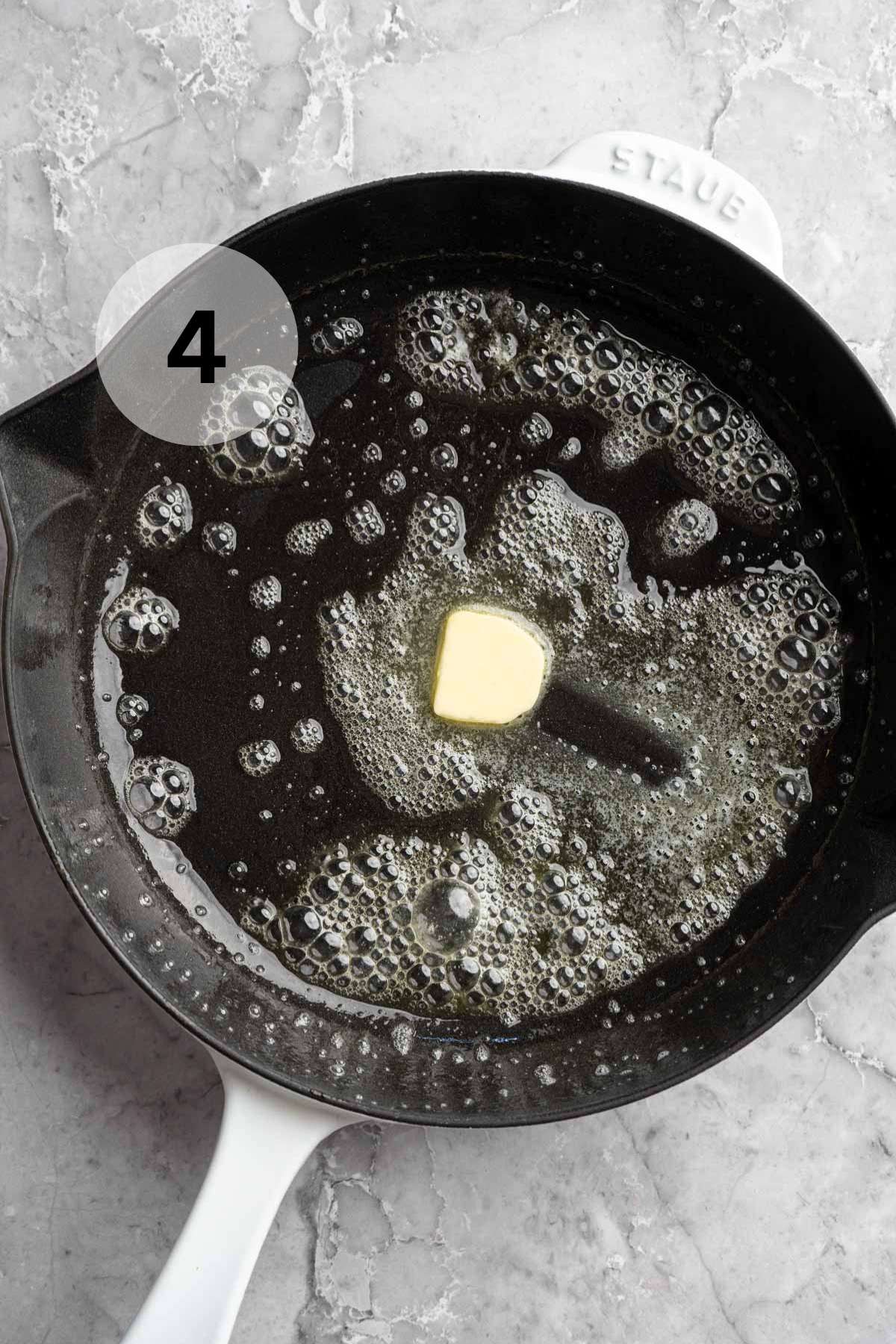Melting butter in an iron skillet.