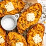 Baked sweet potatoes cut in half and topped with butter.