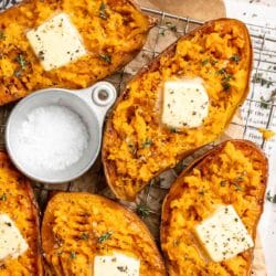Baked sweet potatoes cut in half and topped with butter.