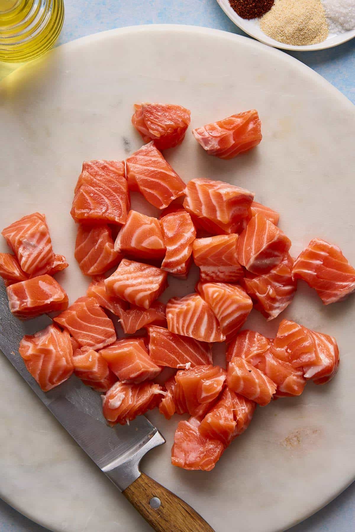 Chunks of cubed salmon on a plate.
