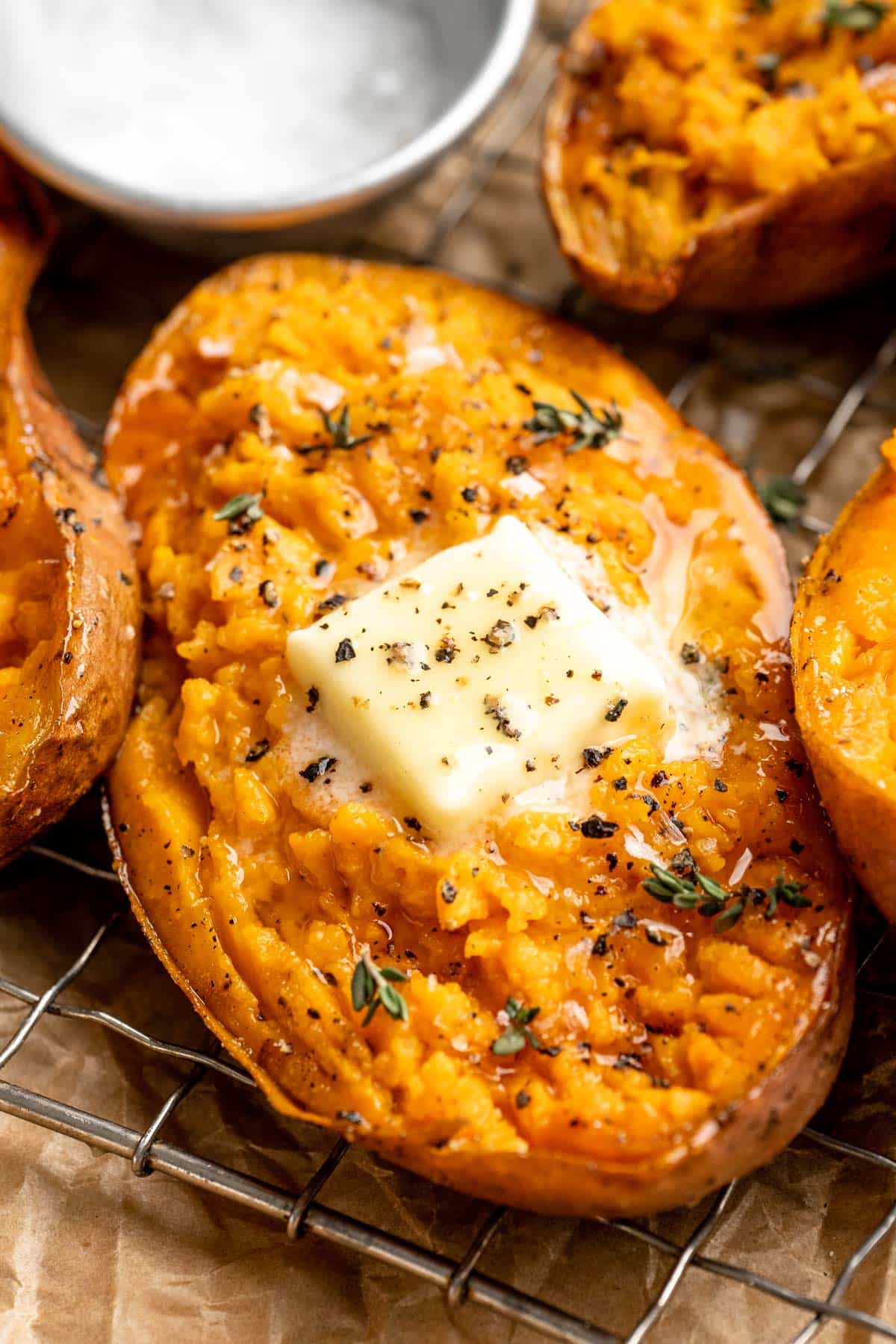 Baked sweet potatoes topped with butter.