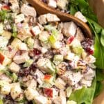 Chicken salad with apples in a bowl with lettuce.