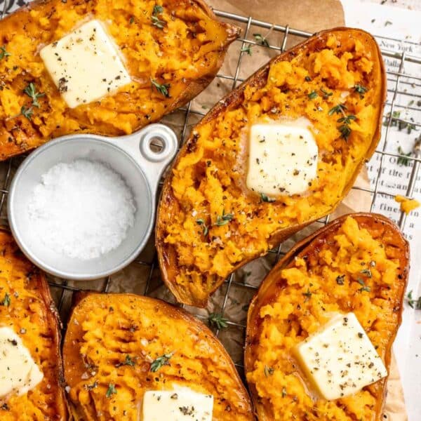 Baked sweet potatoes cut in half and topped with butter.