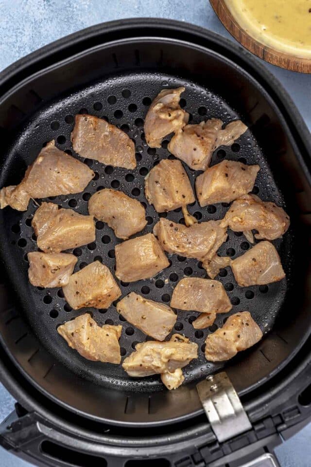 Chicken bites in an air fryer.