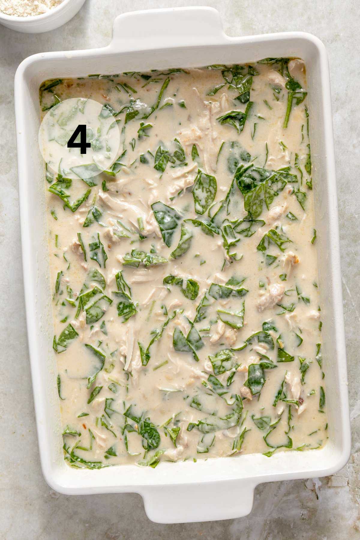 A creamy spinach mixture in a casserole dish.