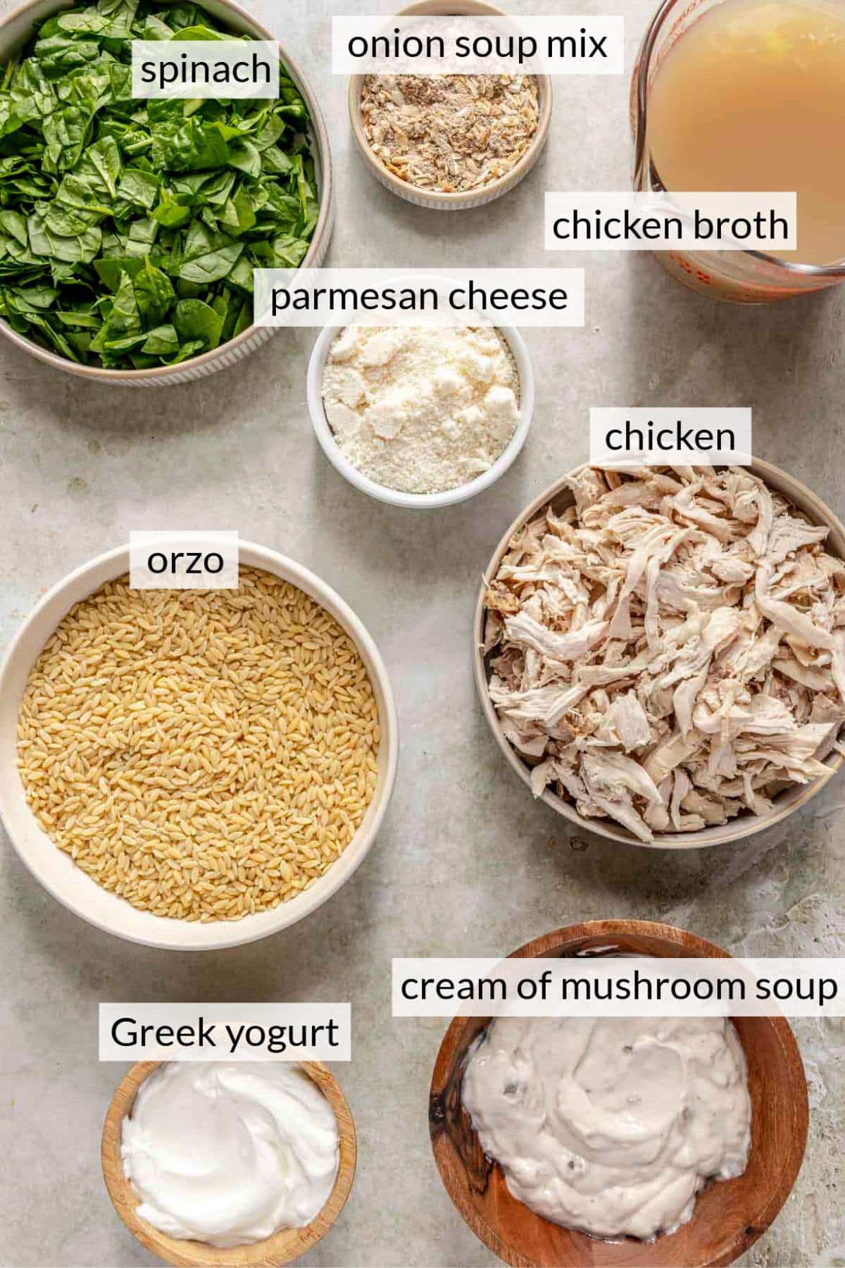 Bowls with shredded chicken, spinach, orzo, greek yogurt, parmesan cheese and chicken broth.