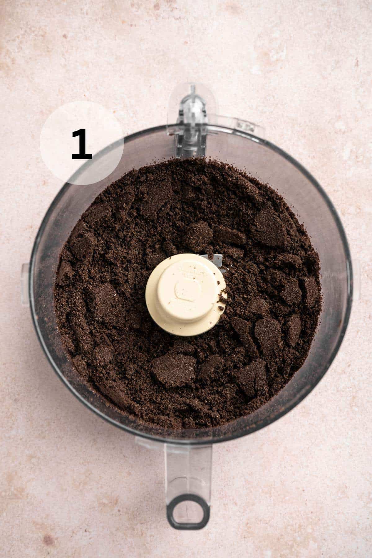 Oreo cookie crumbs in a food processor.