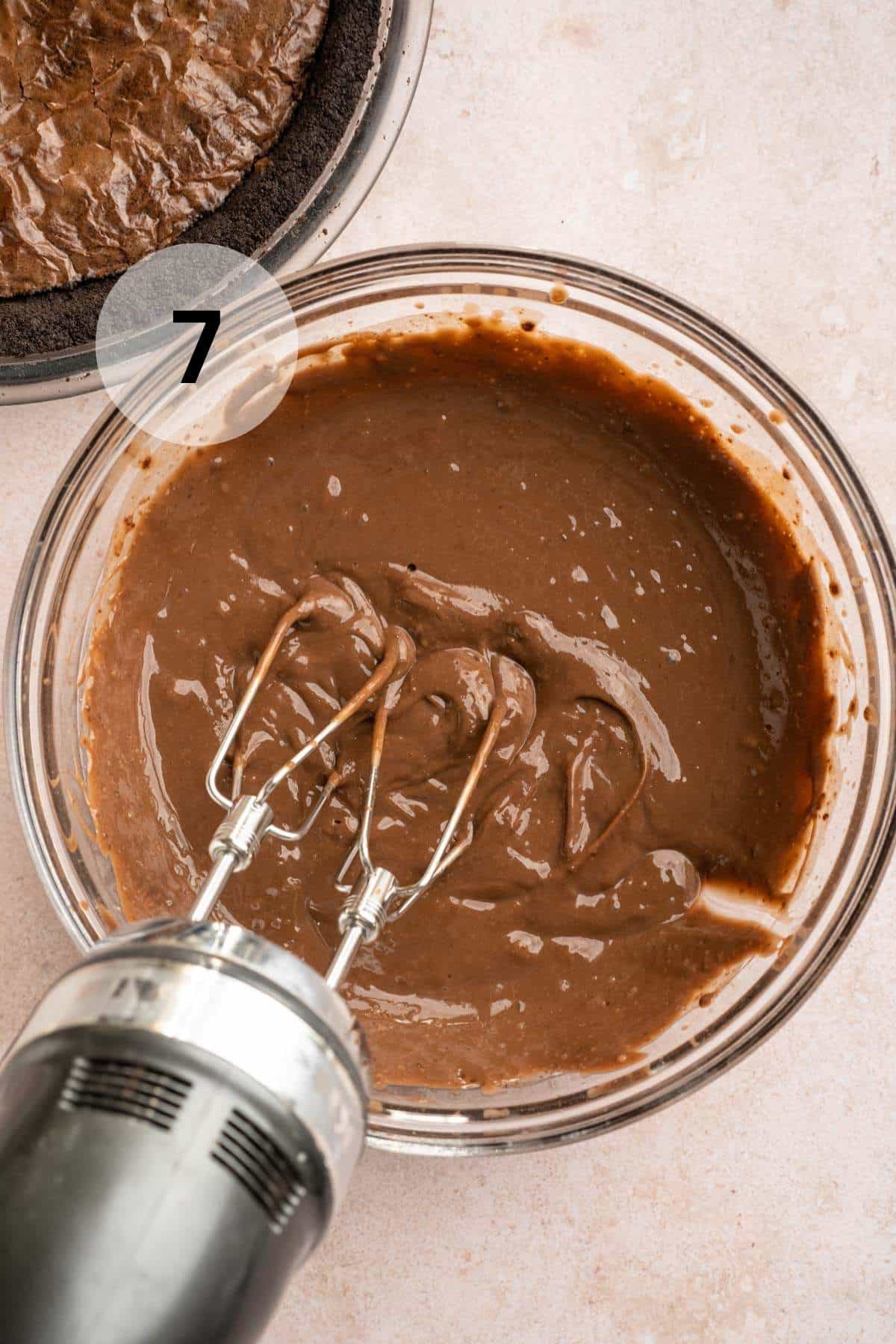 Beating pudding mix with milk.