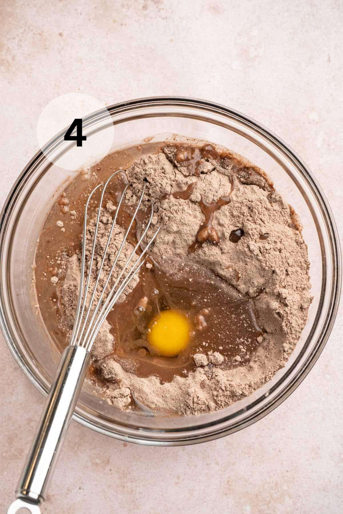 Whisking a brownie mix with water, oil and an egg.