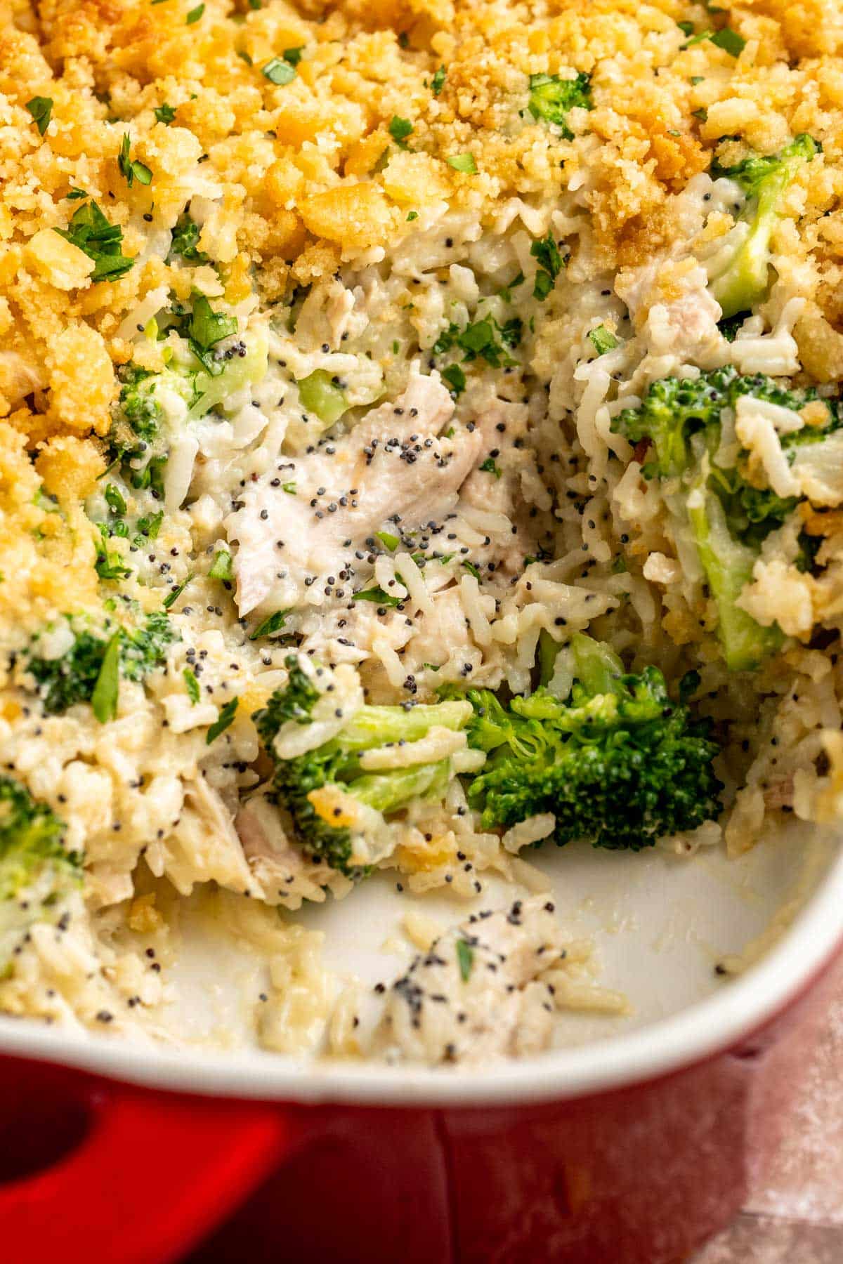 Poppy seed chicken with broccoli in a casserole dish.