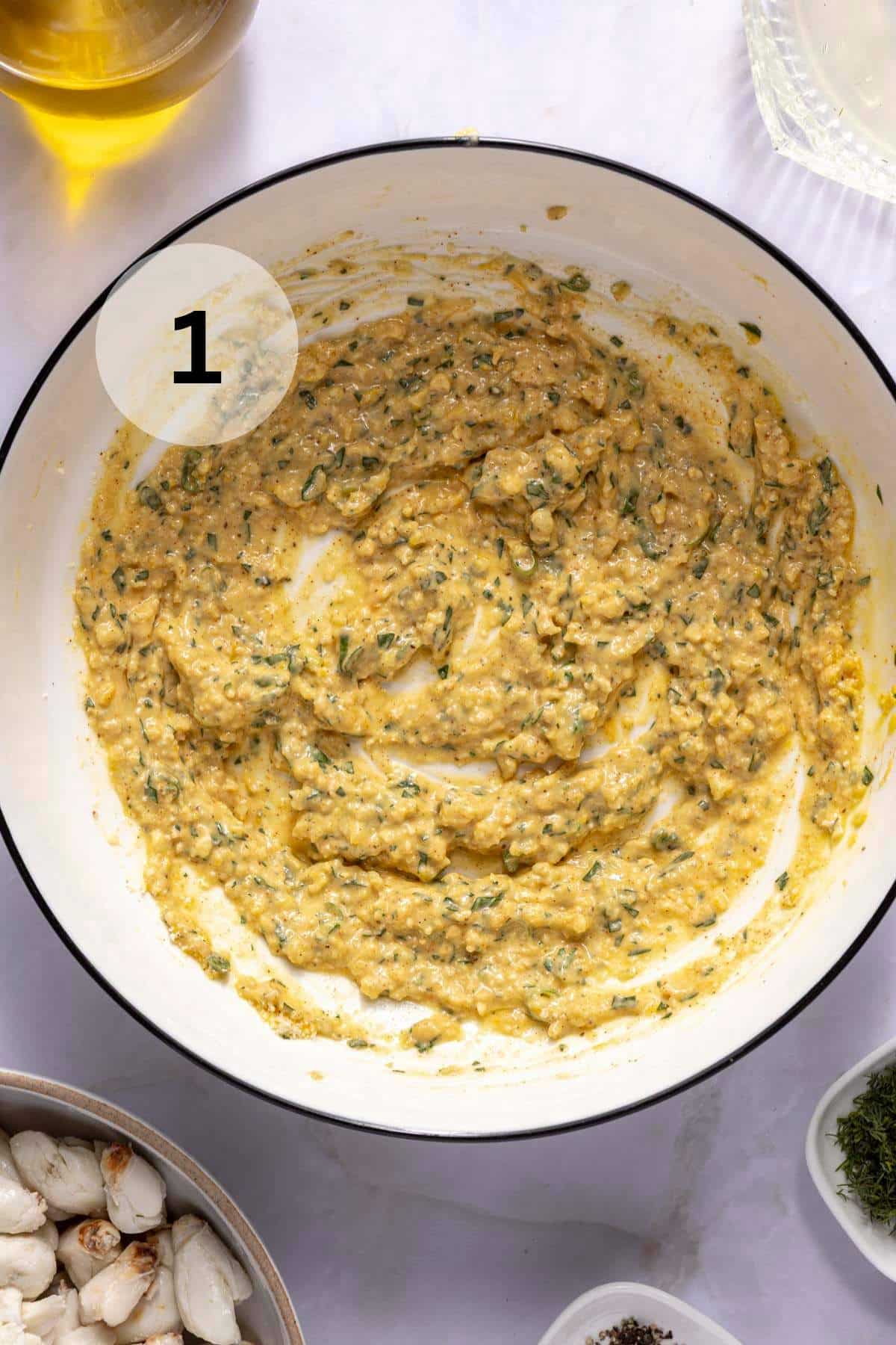 A mixture of egg, mayo, lemon juice and seasonings in a bowl.