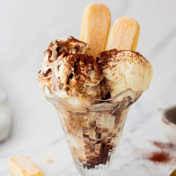 Tiramisu ice cream served in a dessert glass with lady fingers.