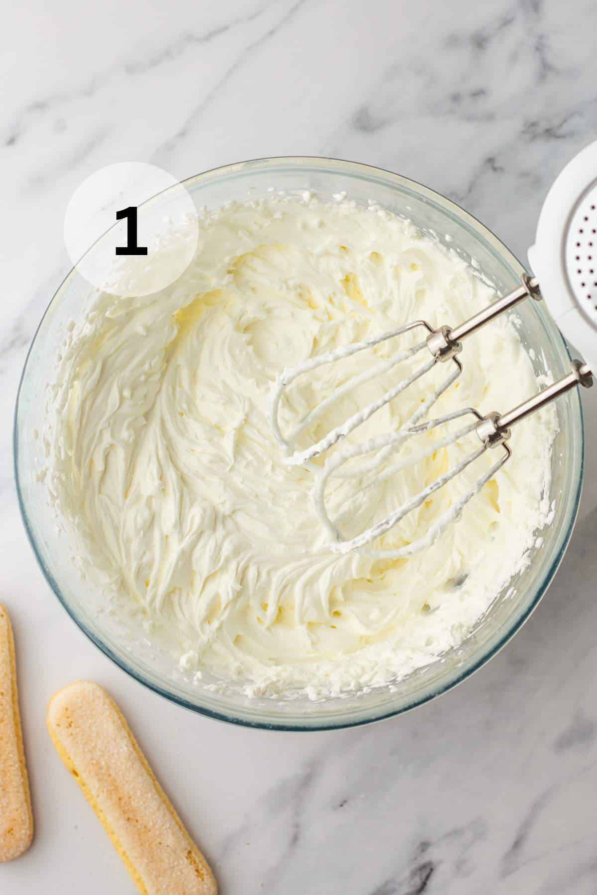 Beating heavy cream into stiff peaks.