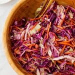 Vinegar coleslaw in a wooden salad bowl.