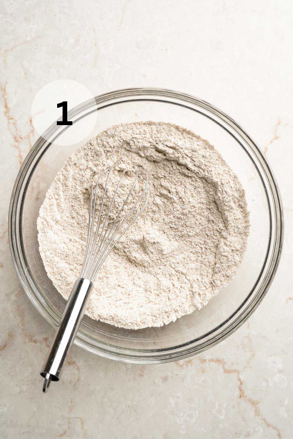 Whisking flour with baking powder and baking soda.