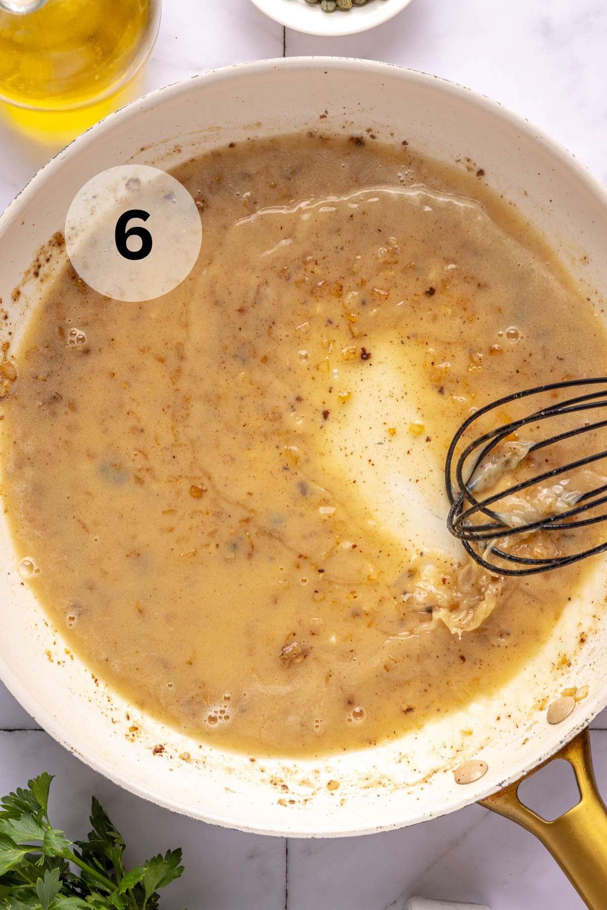 Whisking flour, lemon juice and broth in a pan.