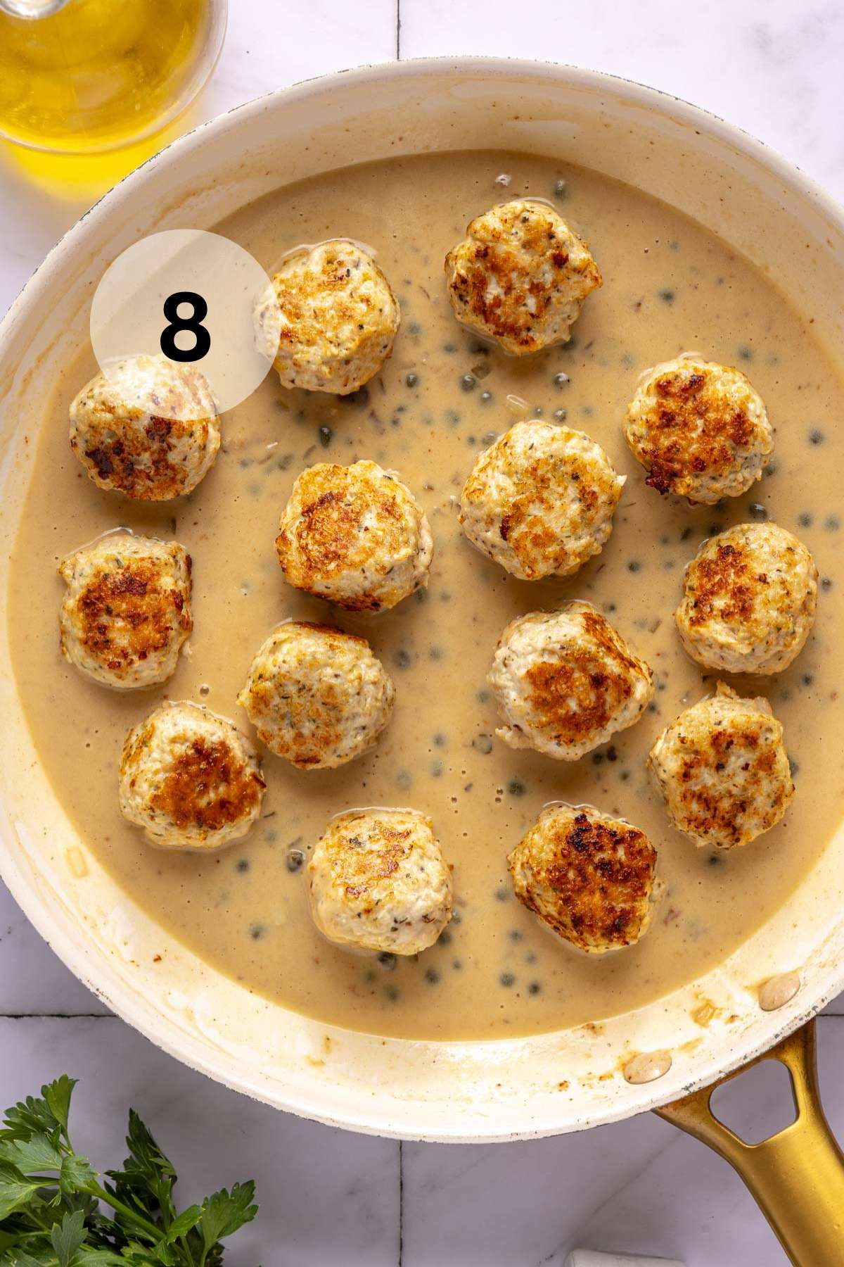 Cooking meatballs in a sauce.