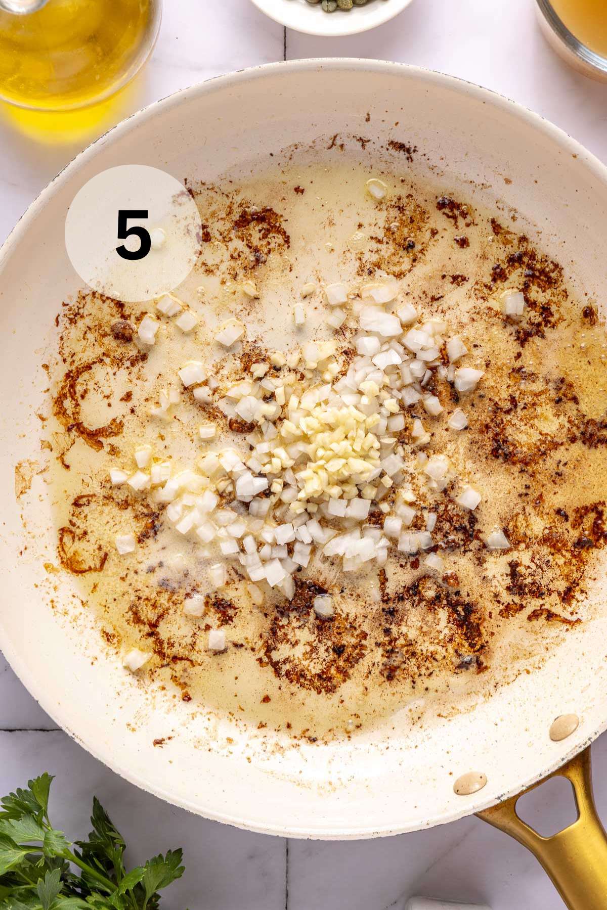Heating onion and garlic in a pan.