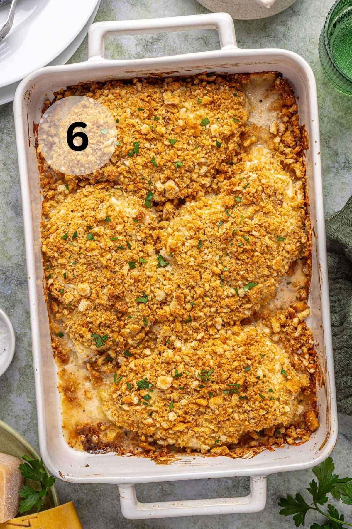 Baked Caesar dressing chicken in a white casserole dish.