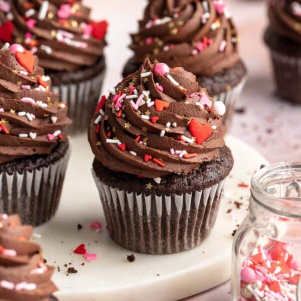 Chocolate cupcakes with frosting and Valentine sprinkles.