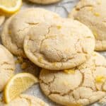 Stacked lemon cookies near lemon wedges.