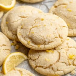 Stacked lemon cookies near lemon wedges.