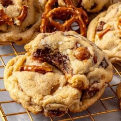 Two kitchen sink cookies stacked with a bite taken out of the top one.