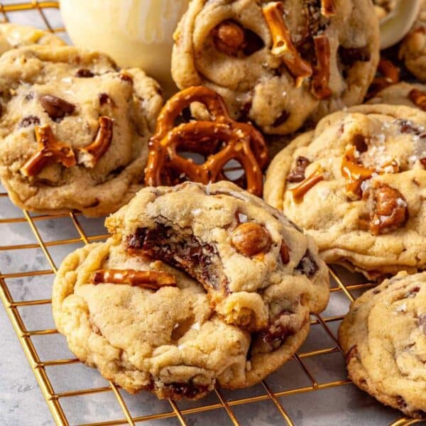 Two kitchen sink cookies stacked with a bite taken out of the top one.