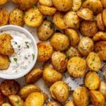 Roasted baby potatoes served with a small bowl of ranch dip.