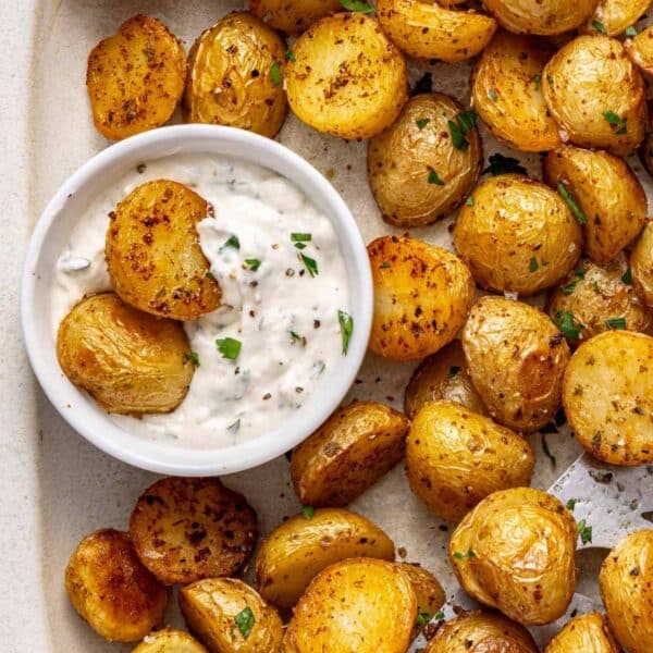 Roasted baby potatoes served with a small bowl of ranch dip.