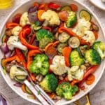 Sautéed vegetables in a large white skillet.