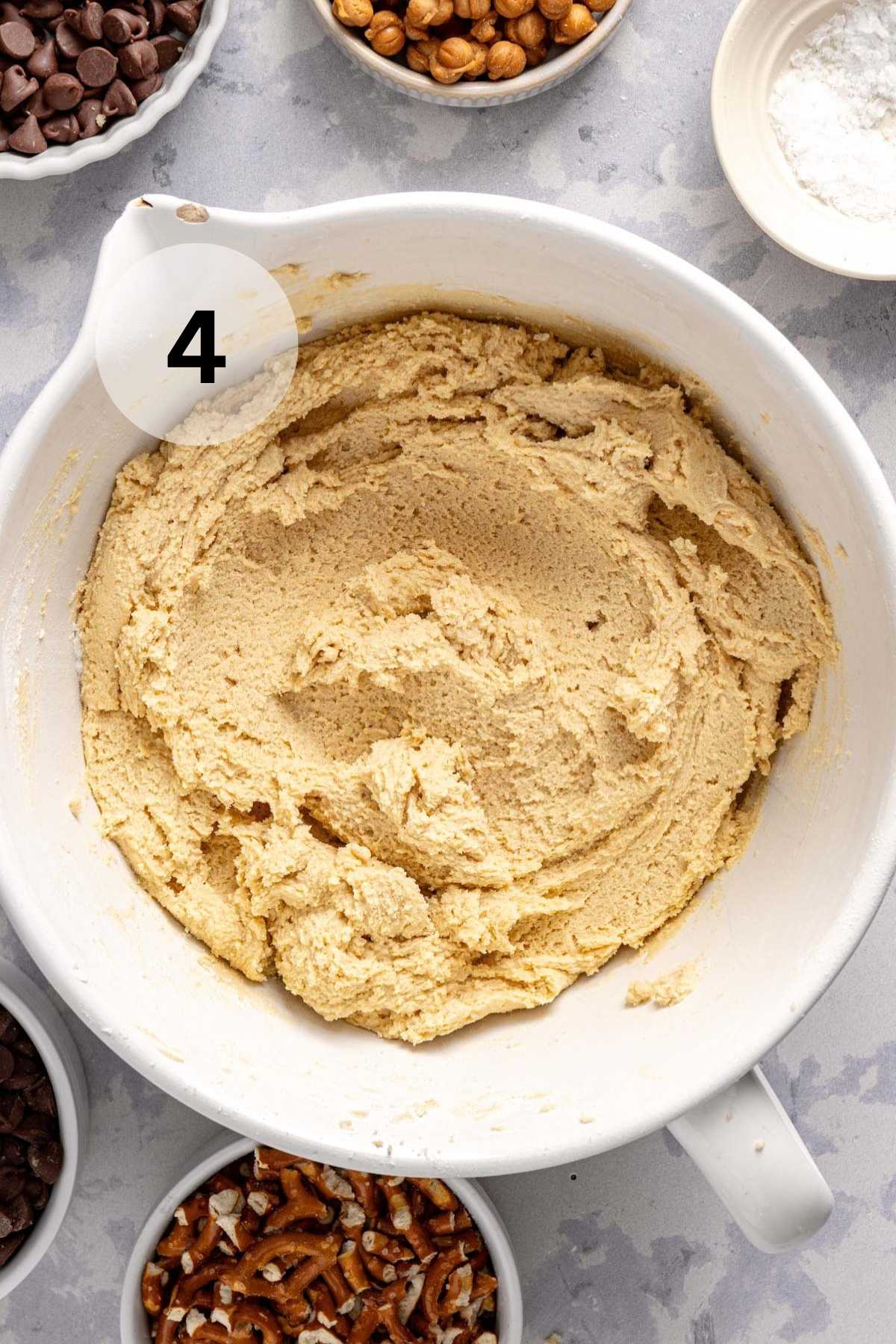 Cookie dough in a large white mixing bowl.