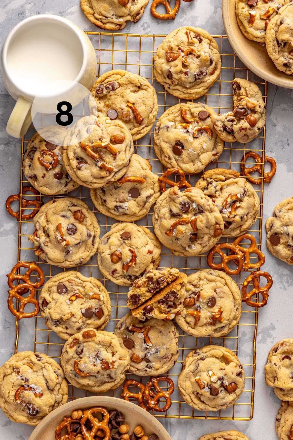 Kitchen sink cookies on a cooling rack with mini pretzels.