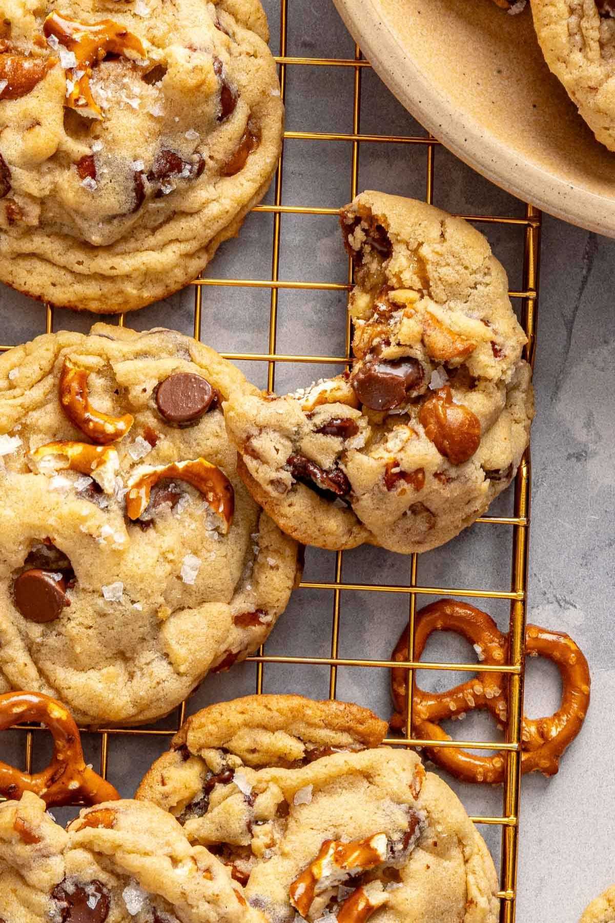 Kitchen sink cookies on a wire rack with a bite taken out of one.