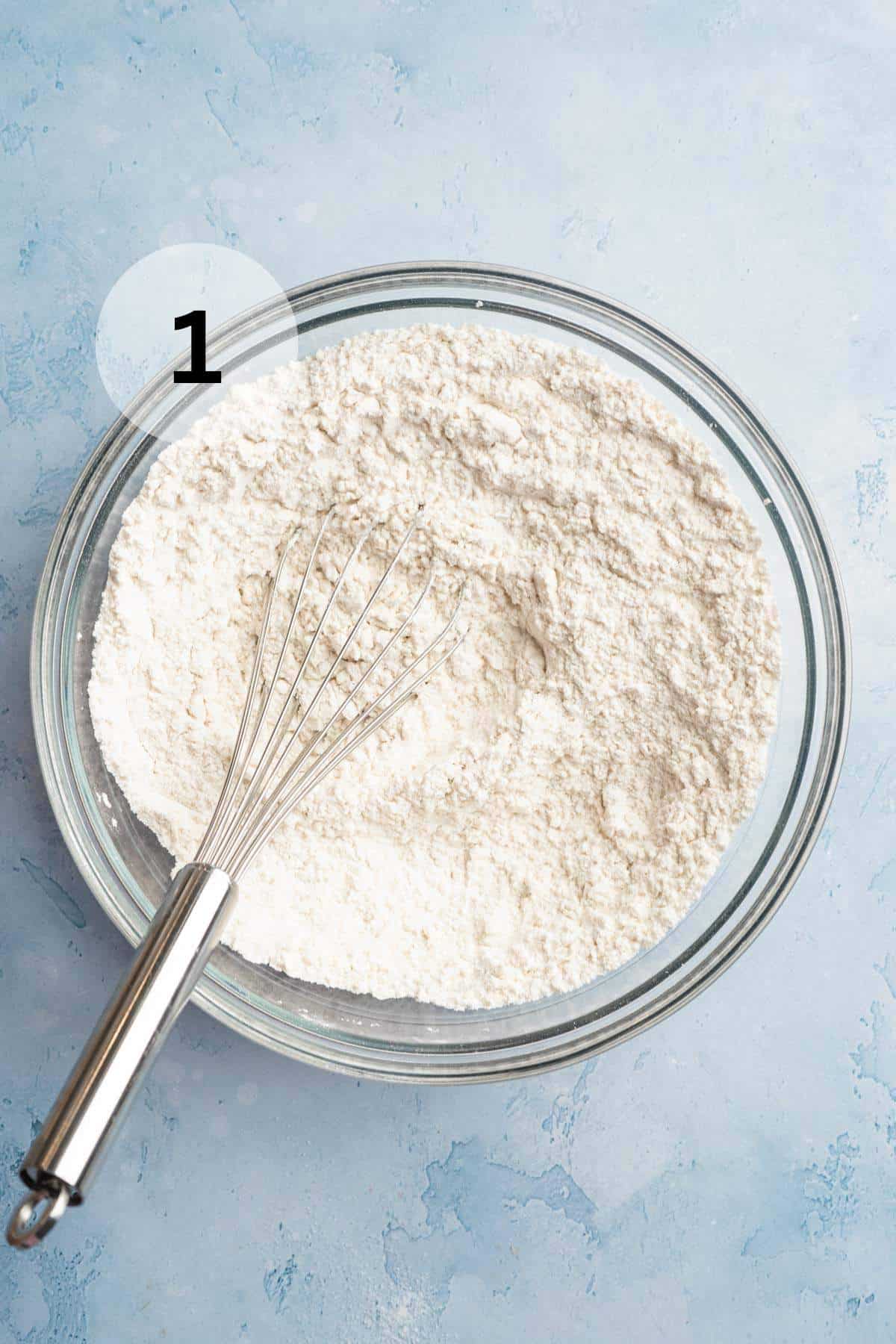 Whisking flour mixture in a large bowl.
