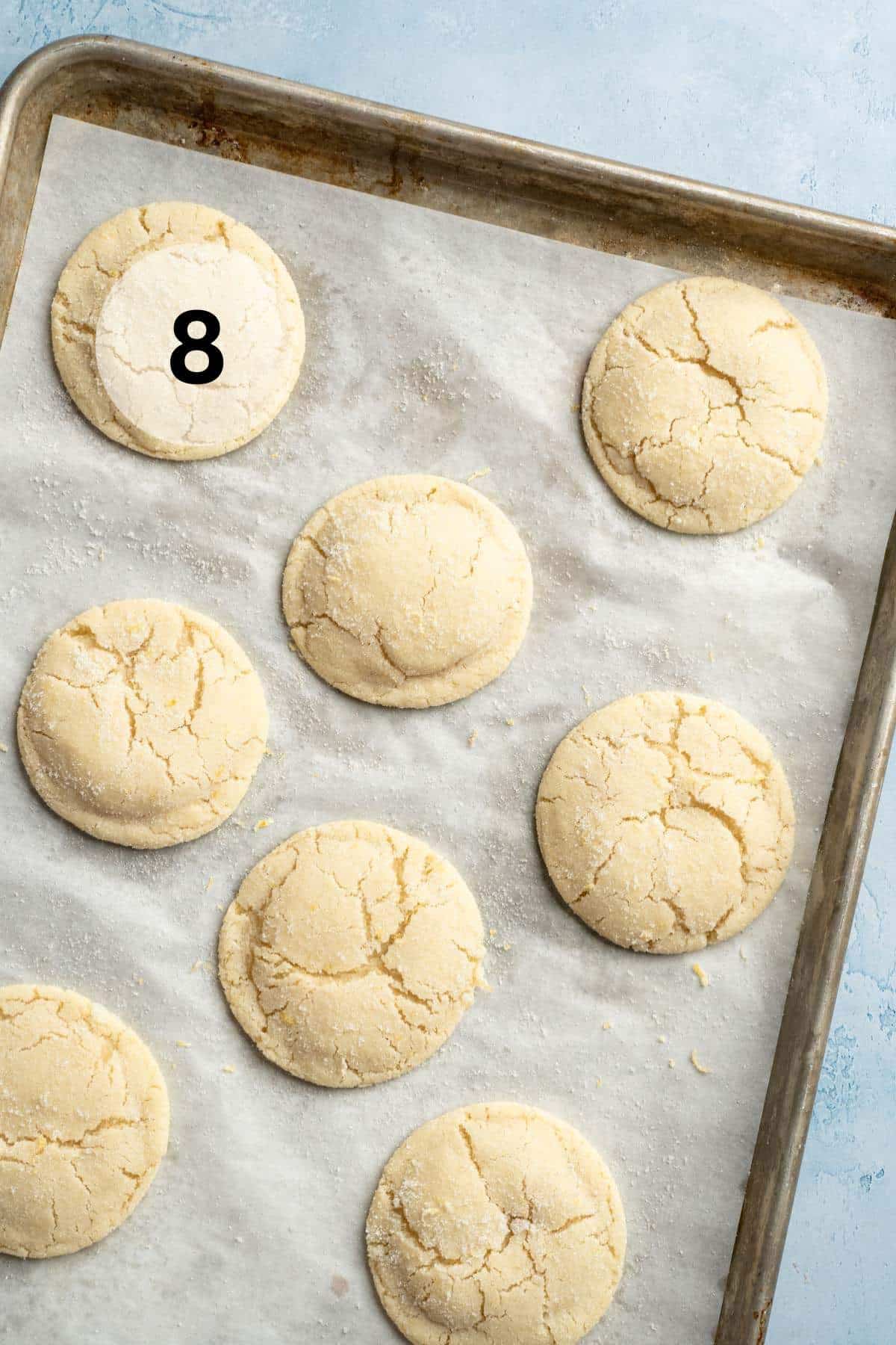 Baked lemon cookies on a parchment lined pan.