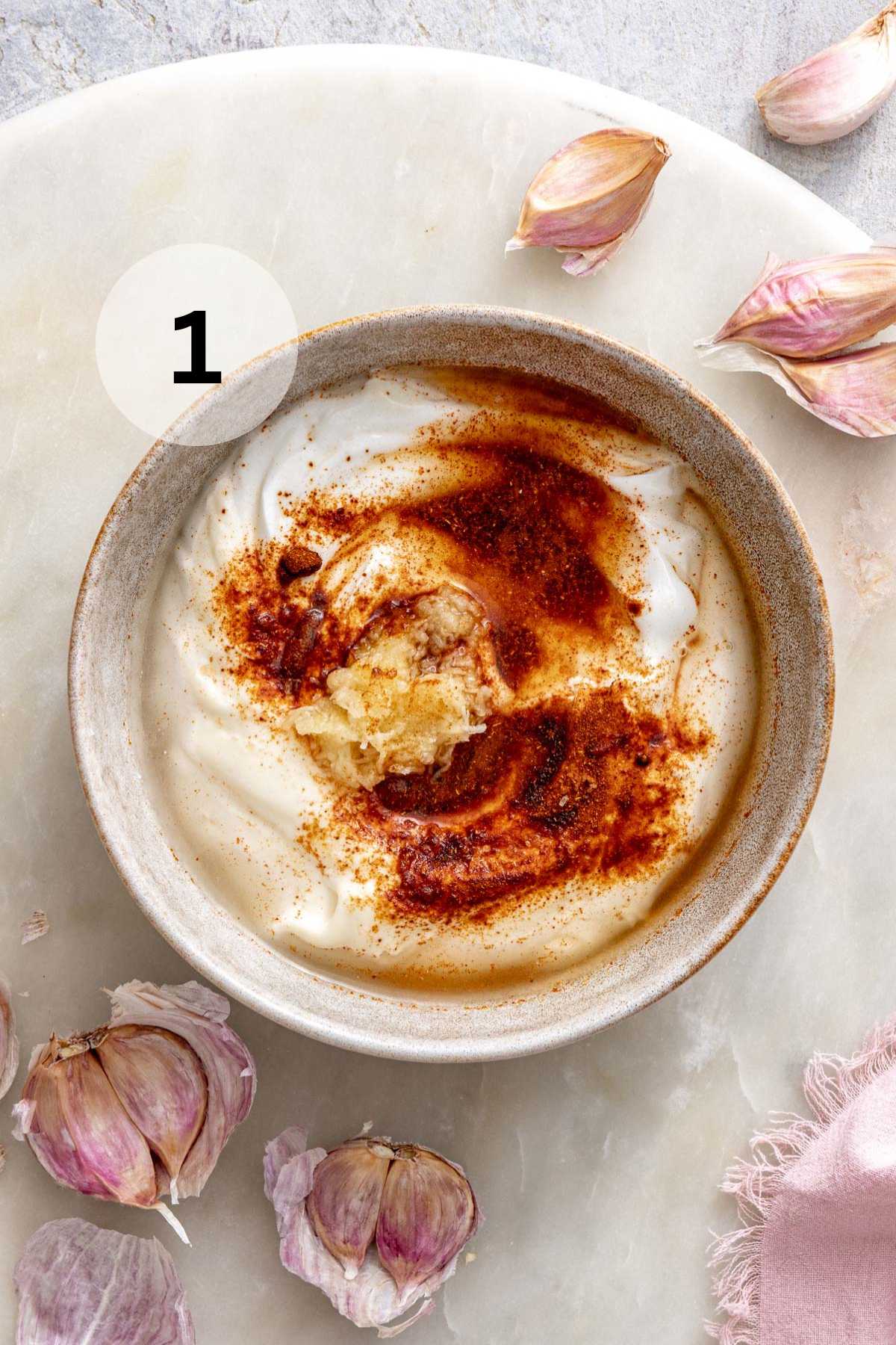 Mayonnaise, Greek yogurt, paprika and garlic in a small bowl.