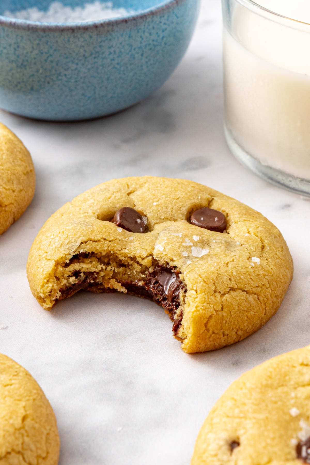 One thick chocolate chip cookie with a bite taken out.