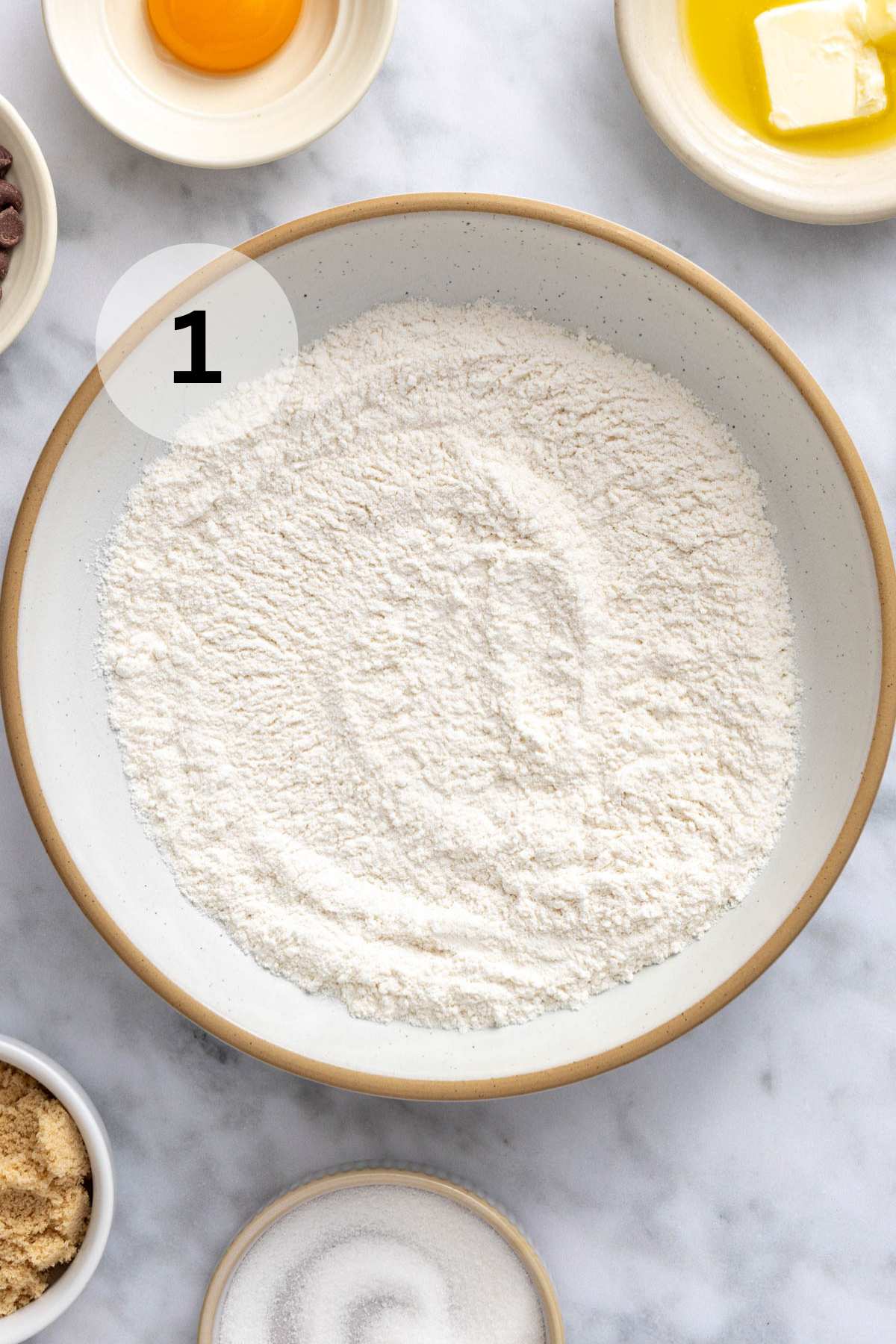 Flour, baking soda, and salt combined in a bowl.