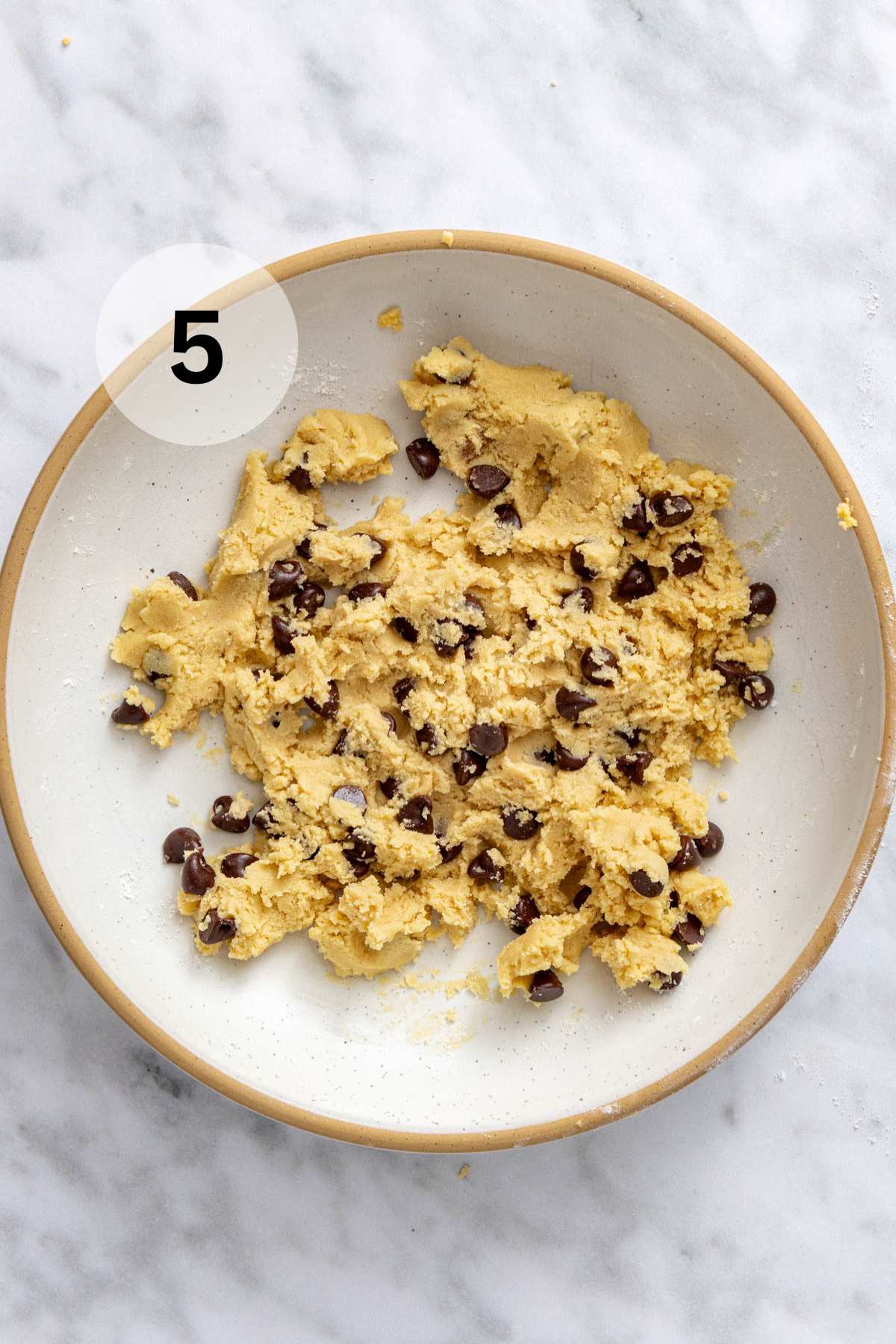 Chocolate chip cookie dough in a bowl.
