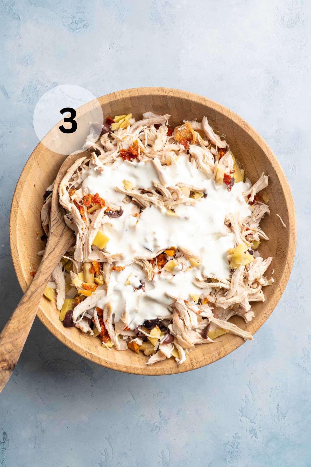 Greek yogurt mixture poured over chicken salad.