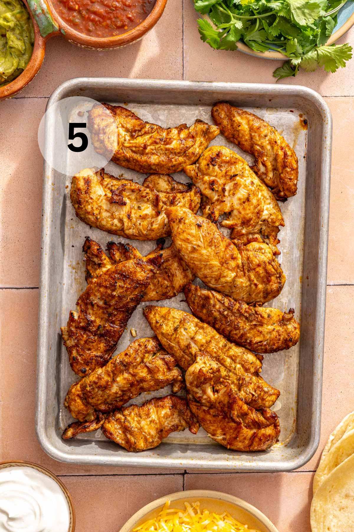 Grilled chicken tenderloins on a platter.