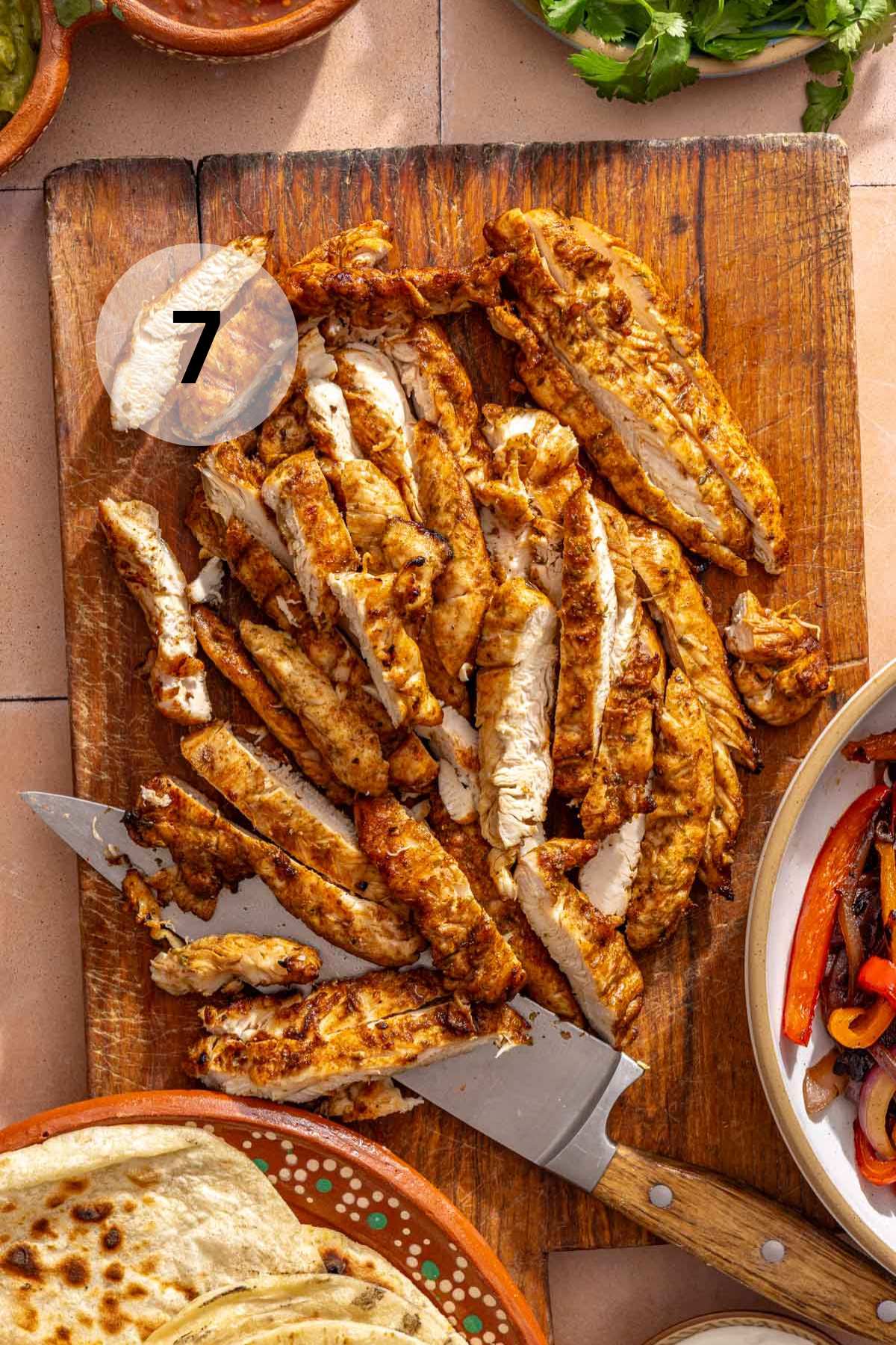 Sliced chicken breast on a cutting board.