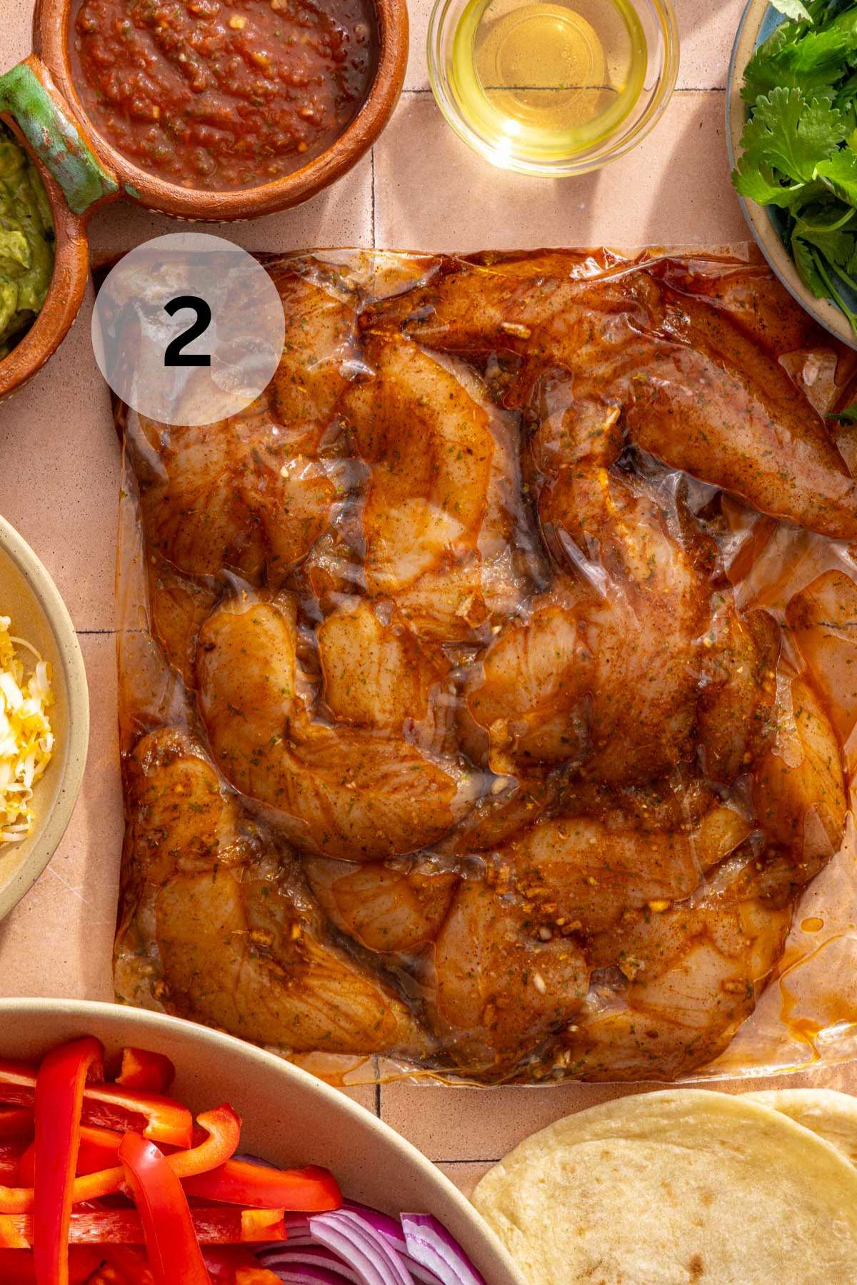 Chicken tenderloins marinating in a bag with spices.