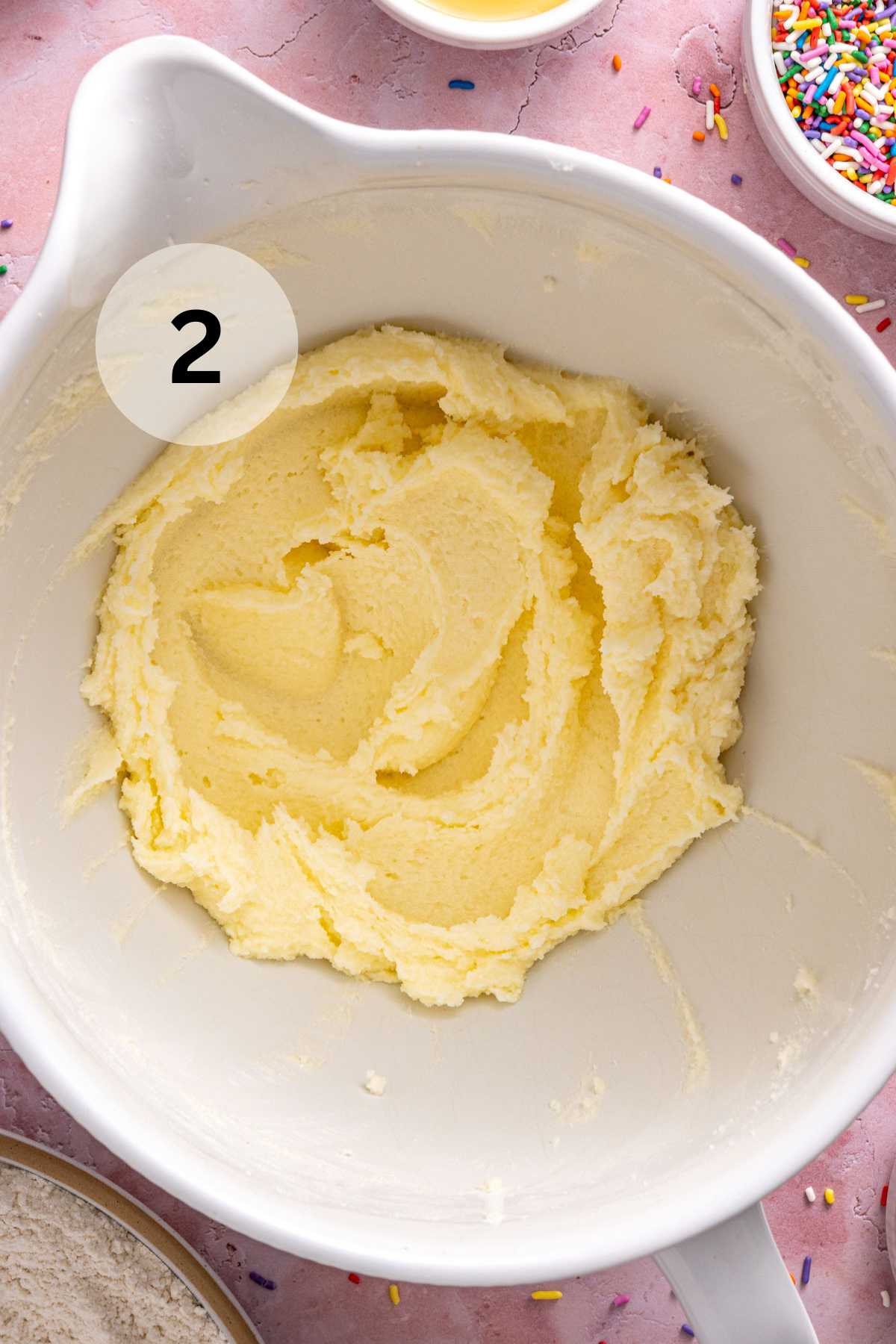 Butter and granulated sugar mixed in a large mixing bowl.