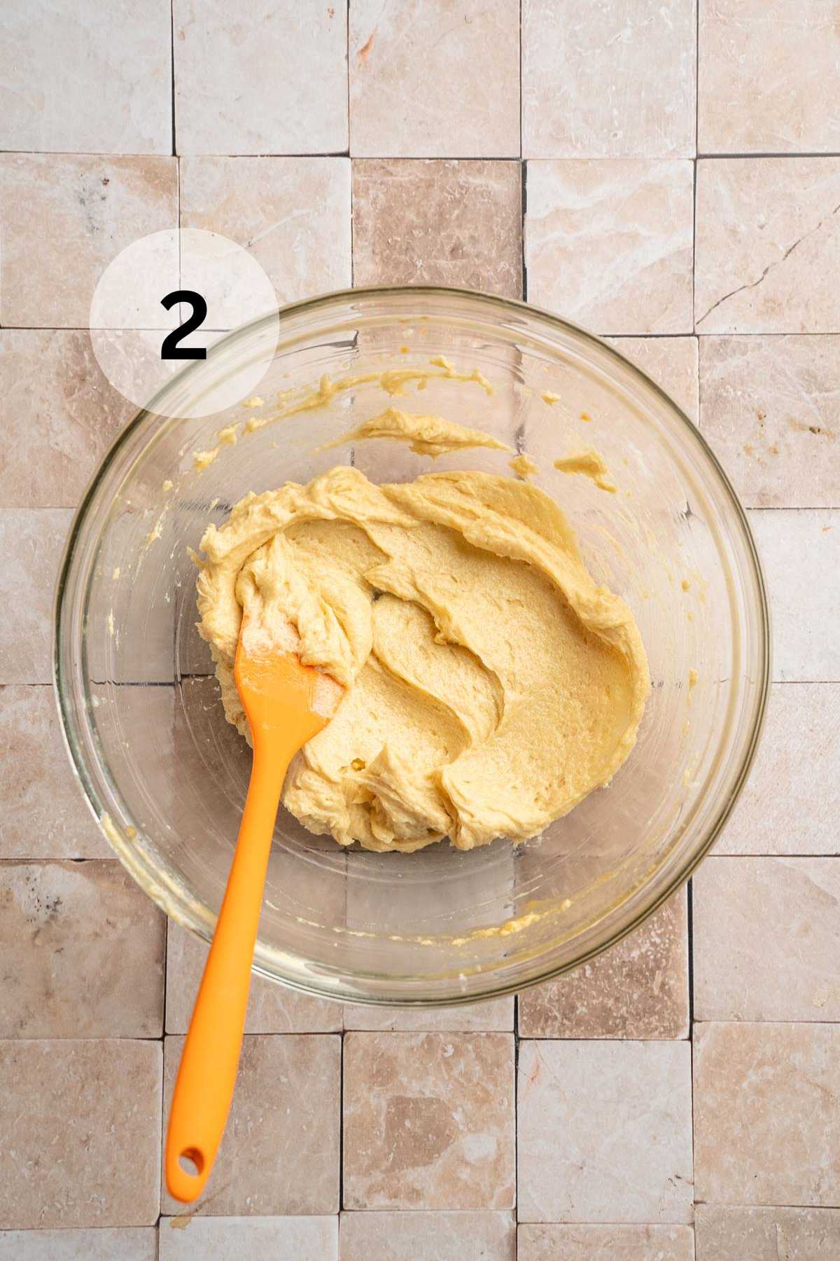 Stirring egg with butter and sugar.