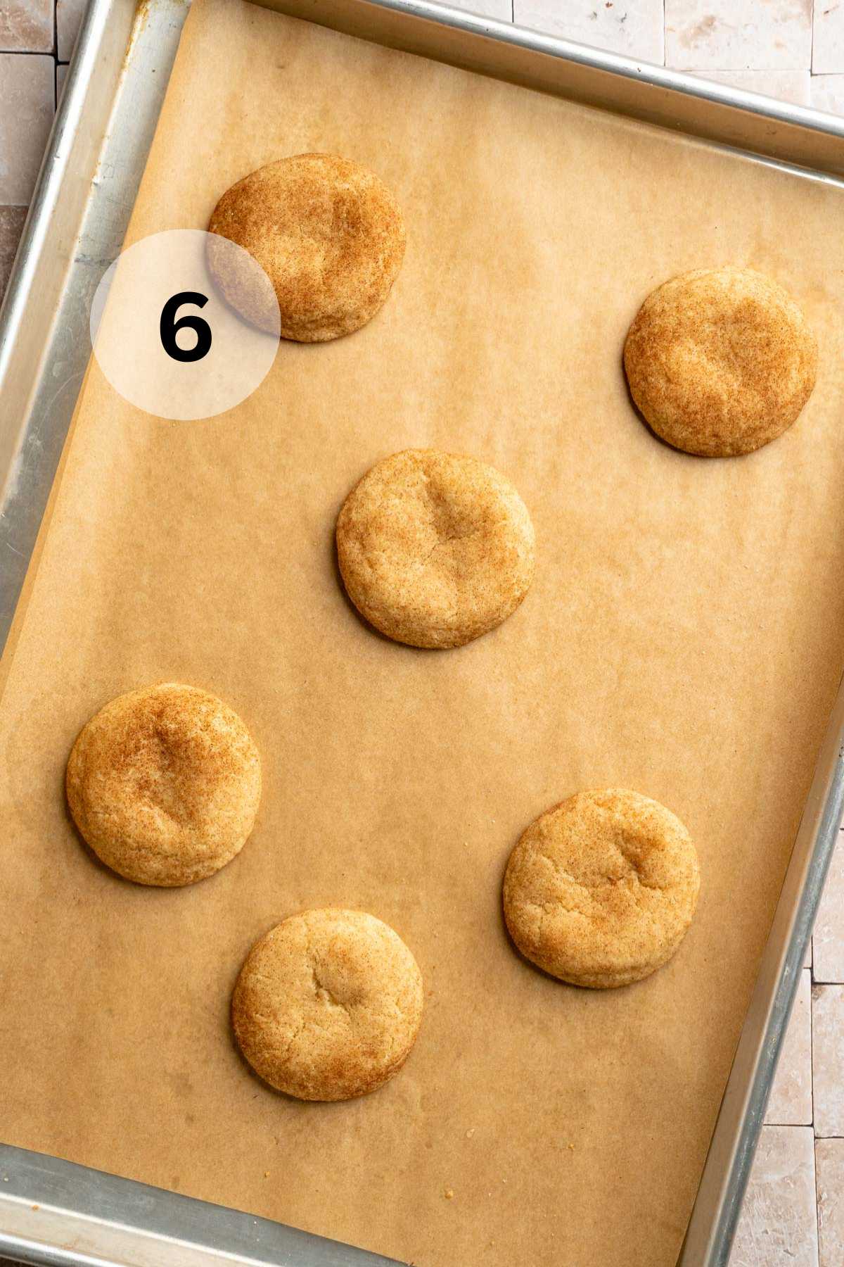 Baked small batch snickerdoodles on a cookie sheet.