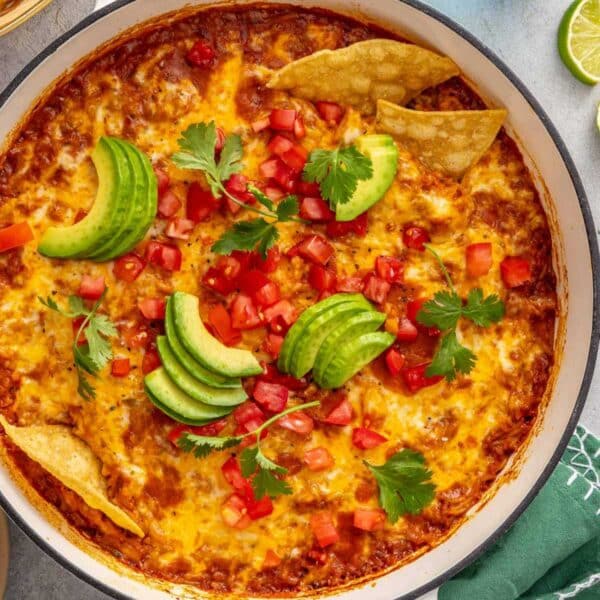 Mexican chicken and rice topped with avocado slices, diced tomatoes and tortilla chips.