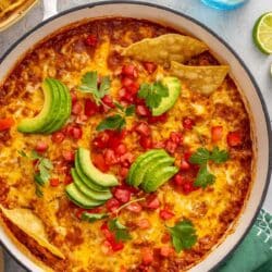 Mexican chicken and rice topped with avocado slices, diced tomatoes and tortilla chips.