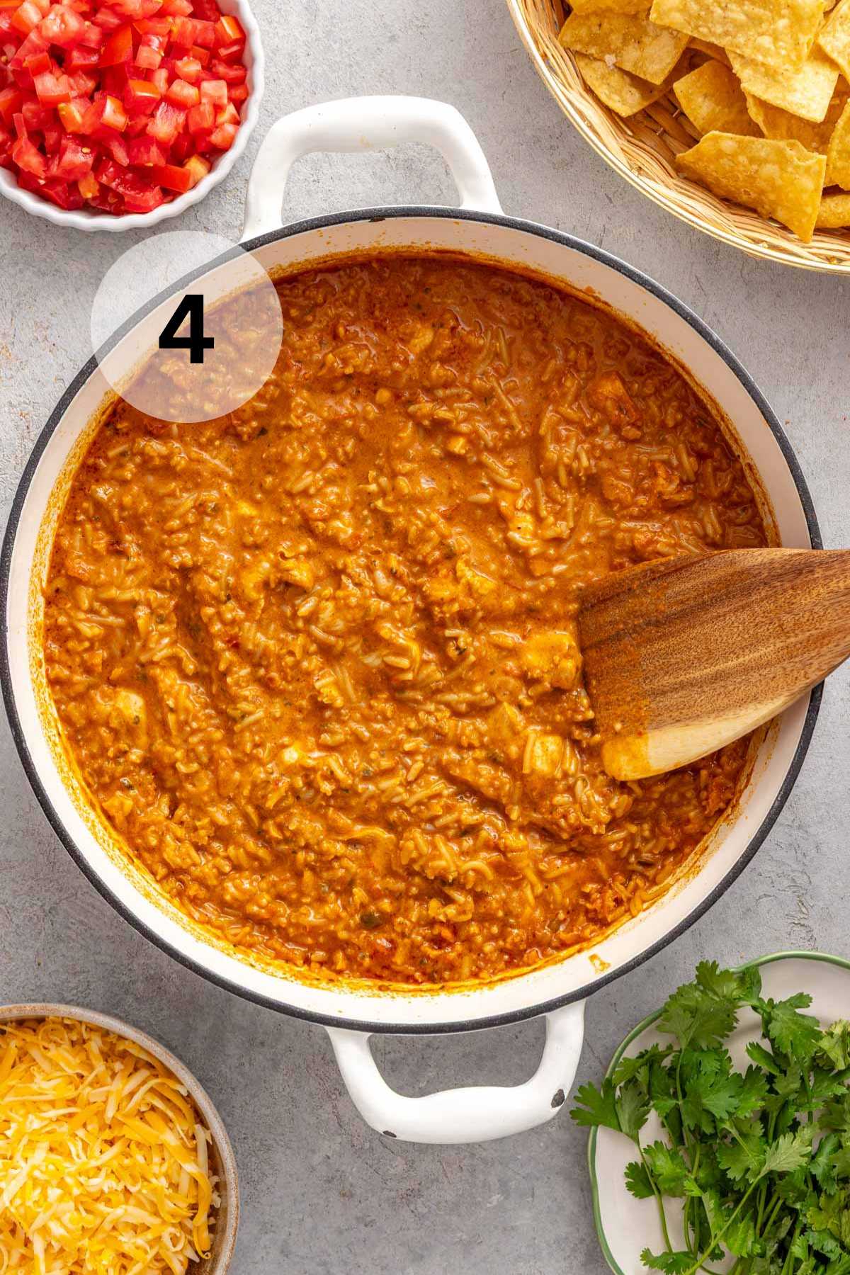 Stirring baked chicken and rice.